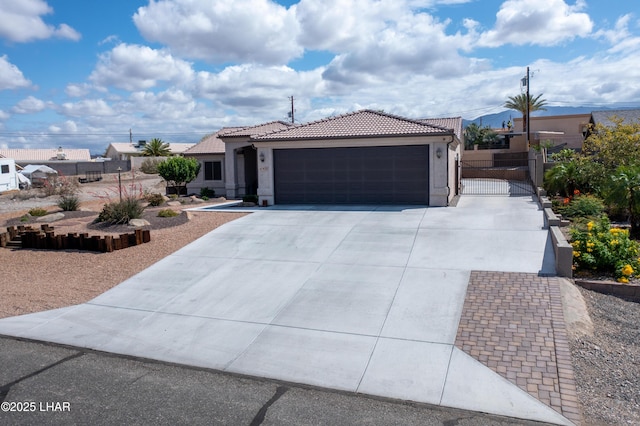 1430 Murphy Dr, Lake Havasu City, AZ 86404 - single story home with a garage, driveway, a tile roof, a gate, and stucco siding