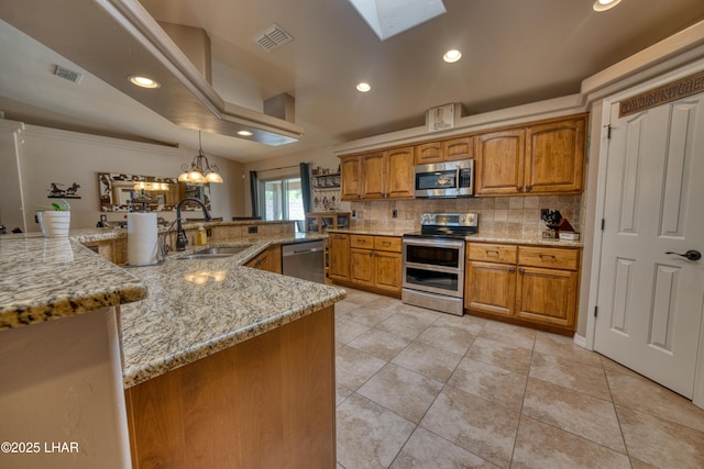 1430 Murphy Dr, Lake Havasu City, AZ 86404 - kitchen with stainless steel appliances, a sink, brown cabinets, decorative backsplash, and a chandelier