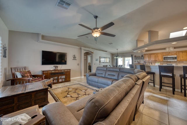 1430 Murphy Dr, Lake Havasu City, AZ 86404 - living room with vaulted ceiling, ceiling fan, arched walkways, light tile patterned flooring, and baseboards