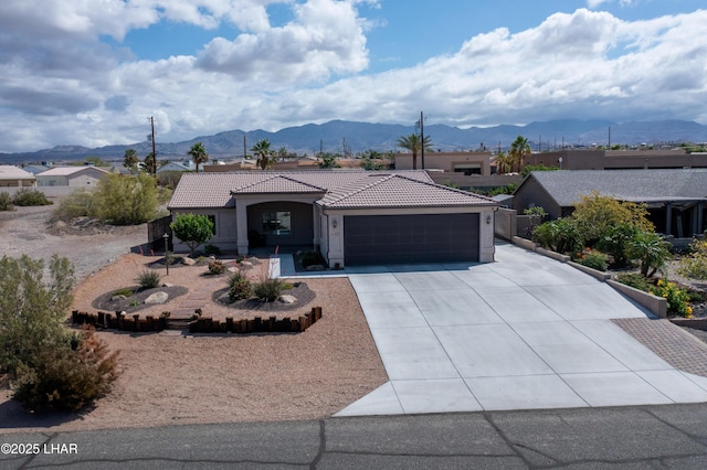 1430 Murphy Dr, Lake Havasu City, AZ 86404 - view of front of home featuring an attached garage, a tiled roof, driveway, a mountain view, and stucco siding