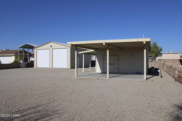 49674 Rainbow Ave, Quartzsite, AZ 85346 - back of house with a garage and an outdoor structure