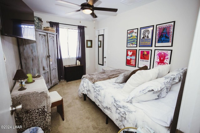 bedroom featuring light colored carpet and ceiling fan