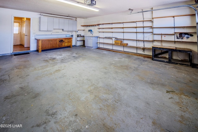 garage with a workshop area and a garage door opener