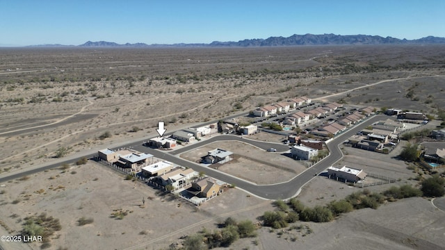 birds eye view of property with view of desert and a mountain view