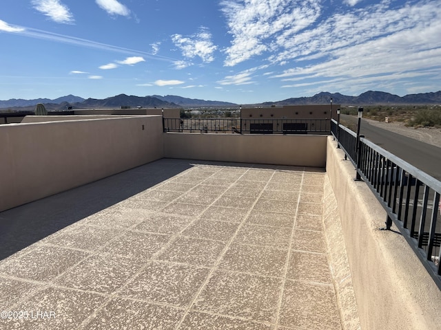 view of patio / terrace with a balcony and a mountain view