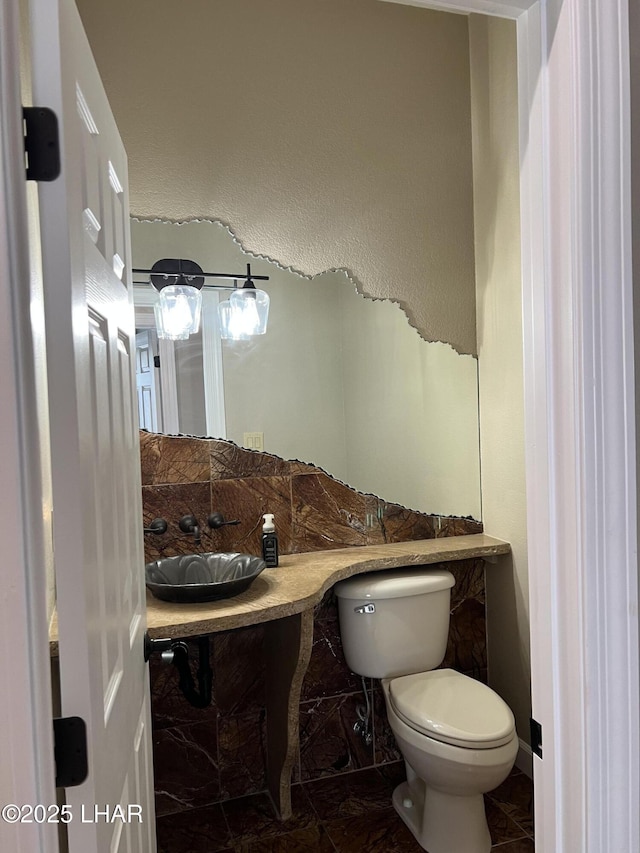 bathroom featuring toilet and a sink