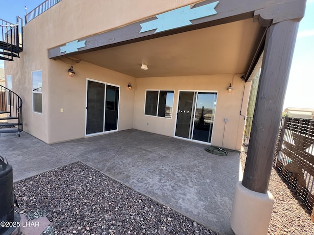 back of house featuring a patio area and stucco siding