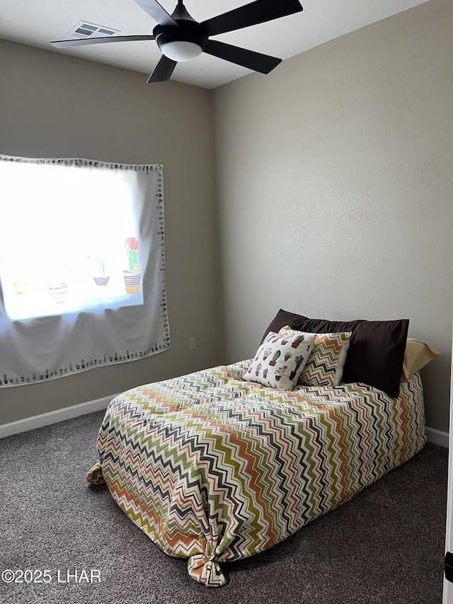 bedroom with carpet floors, visible vents, baseboards, and a ceiling fan