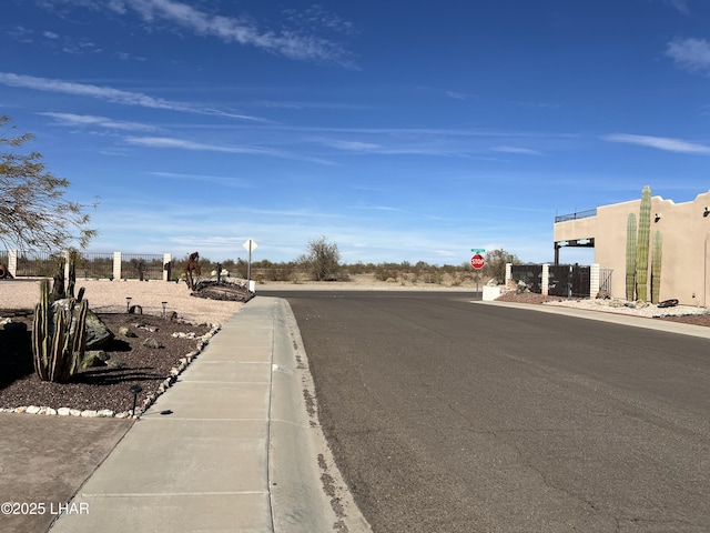 view of road with traffic signs, curbs, and sidewalks