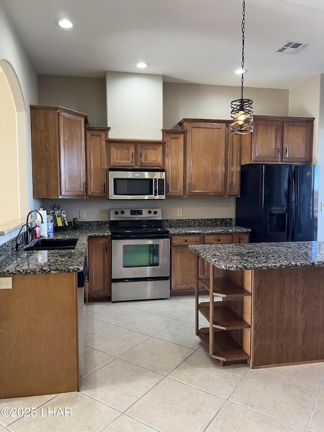 kitchen with open shelves, visible vents, appliances with stainless steel finishes, a sink, and dark stone counters