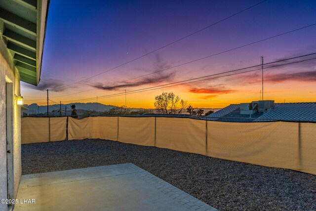 yard at dusk with a patio