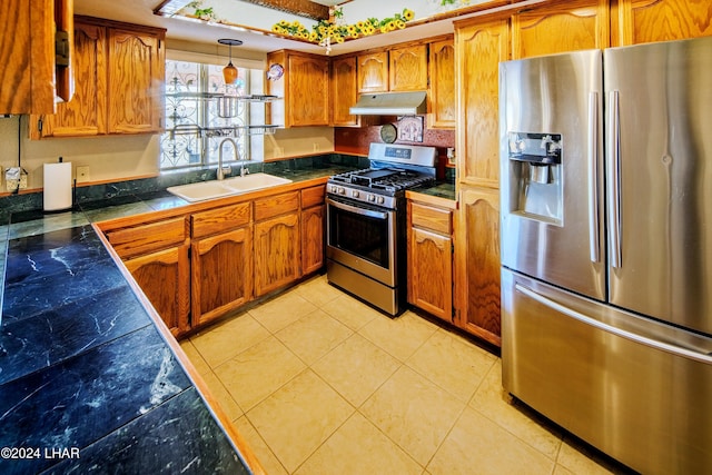 kitchen with pendant lighting, sink, light tile patterned floors, and appliances with stainless steel finishes