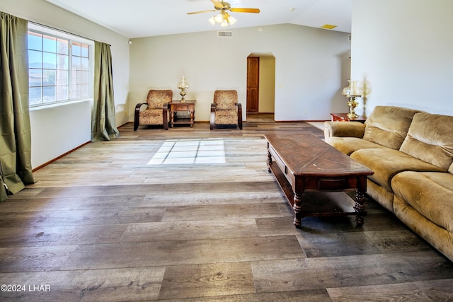 living room featuring wood-type flooring, vaulted ceiling, and ceiling fan