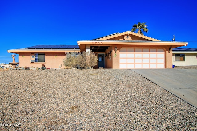 view of front of home with a garage and solar panels