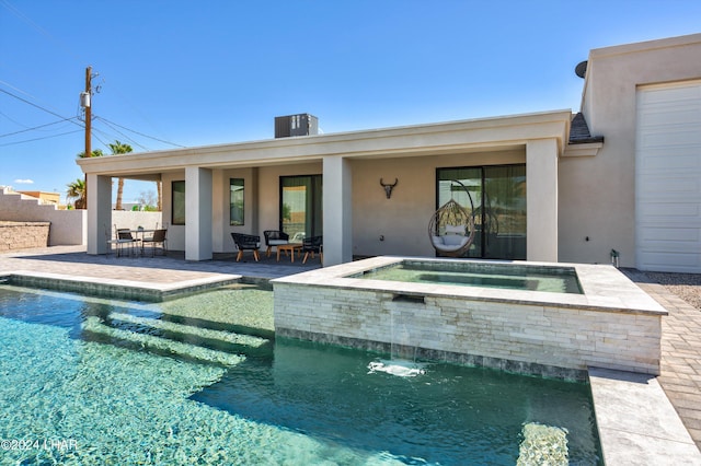 view of pool featuring an in ground hot tub and a patio area