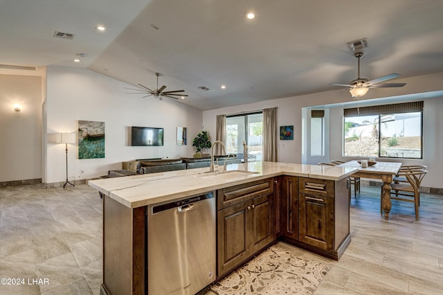 kitchen with lofted ceiling, sink, dishwasher, an island with sink, and ceiling fan