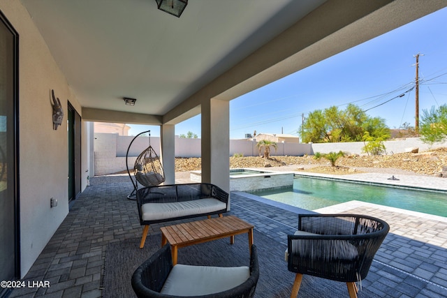 view of patio / terrace with a pool with hot tub