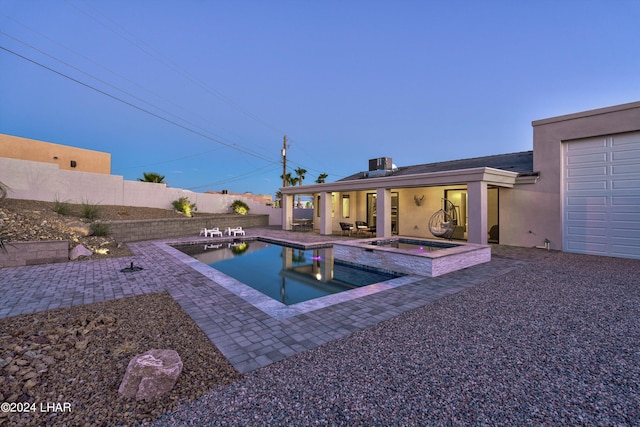 view of pool featuring a patio area and an in ground hot tub