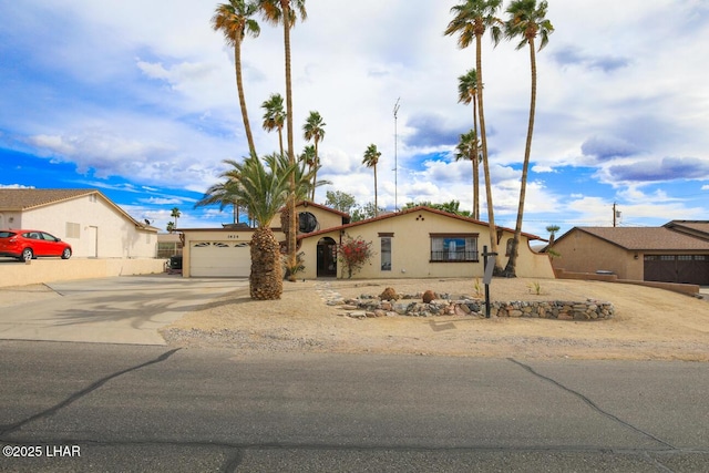 view of front of home with driveway, a garage, and stucco siding