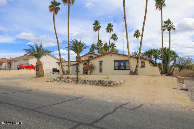 mediterranean / spanish-style home with stucco siding