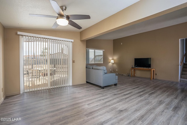 unfurnished living room featuring hardwood / wood-style flooring and ceiling fan