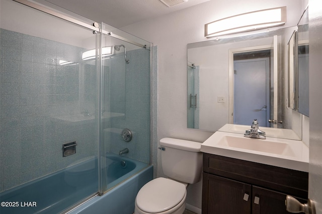 full bathroom featuring toilet, shower / bath combination with glass door, and vanity