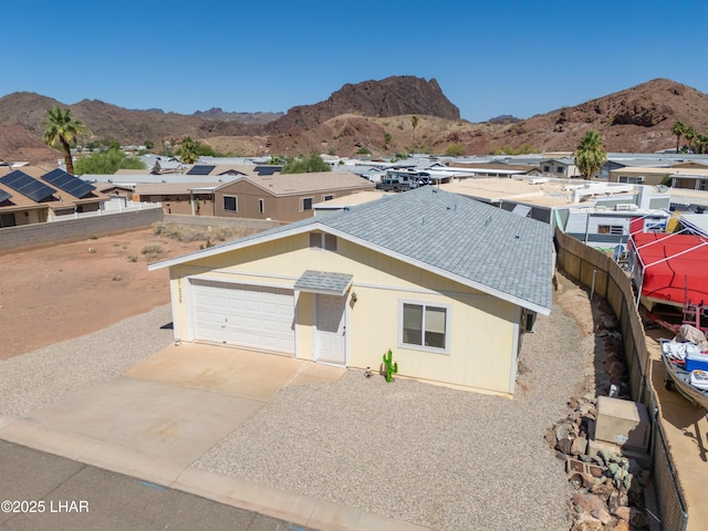 37339 Buckskin Cir, Parker, AZ 85344 - view of front facade featuring a mountain view, driveway, roof with shingles, and fence