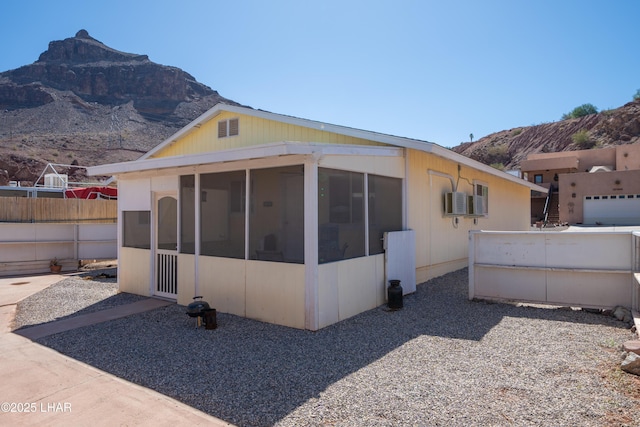 37339 Buckskin Cir, Parker, AZ 85344 - rear view of property featuring a sunroom, a mountain view, and fence
