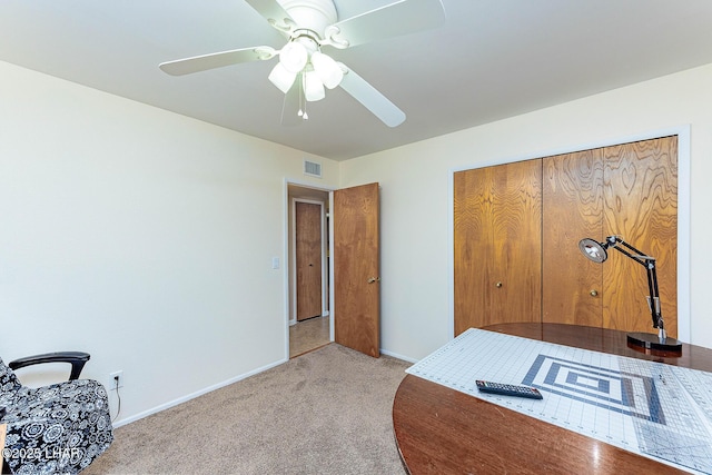 bedroom featuring ceiling fan, light carpet, visible vents, baseboards, and a closet