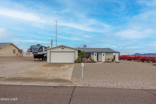 ranch-style house with concrete driveway