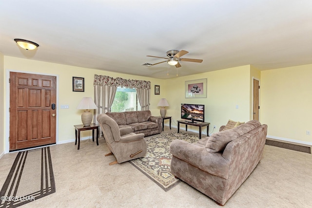 living room with ceiling fan, visible vents, and baseboards