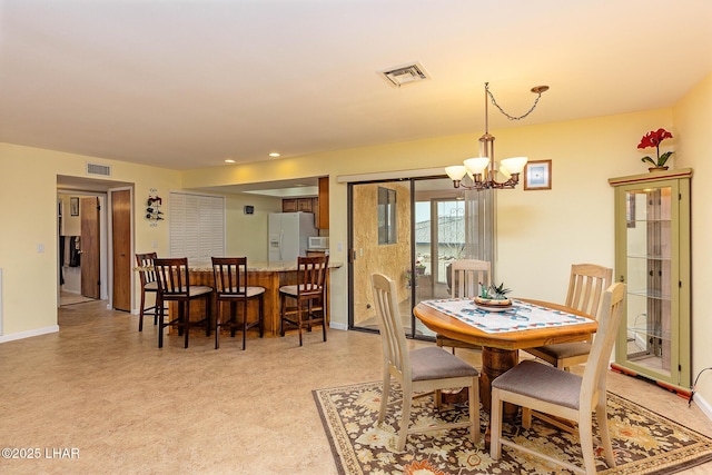 dining space with an inviting chandelier, baseboards, and visible vents