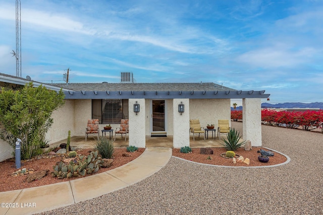 view of front of property featuring a patio and stucco siding