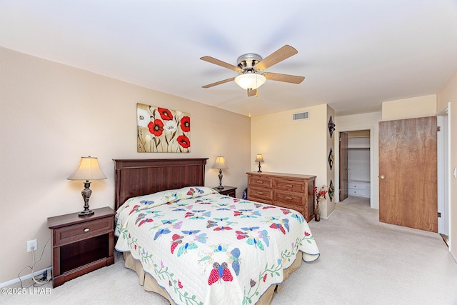 carpeted bedroom with ceiling fan and visible vents