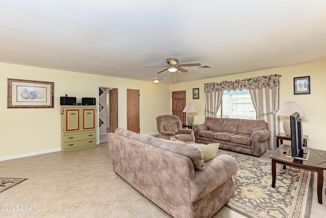 living area with a ceiling fan, visible vents, and baseboards