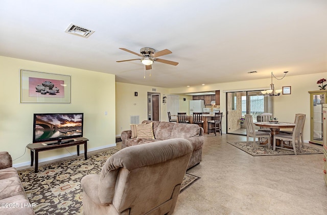 living room with ceiling fan with notable chandelier, visible vents, and baseboards