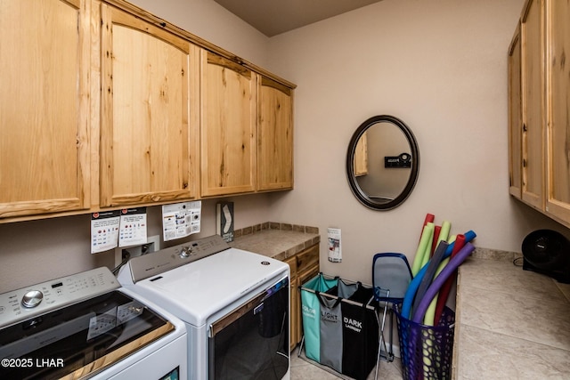 laundry room featuring independent washer and dryer and cabinet space