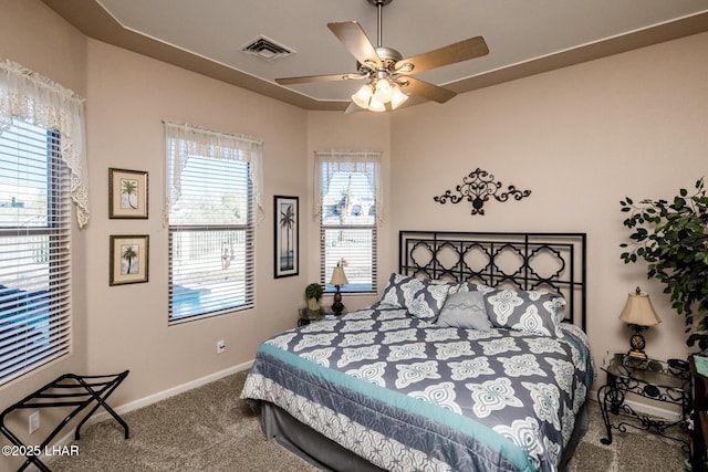 bedroom with a ceiling fan, carpet flooring, visible vents, and baseboards