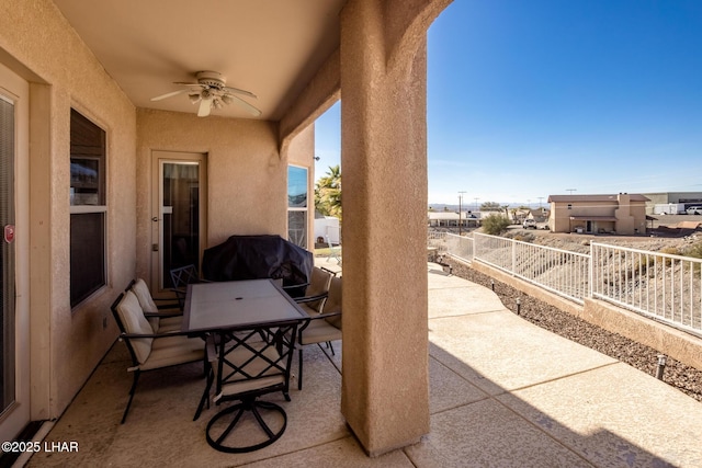 view of patio with fence, outdoor dining area, and a ceiling fan