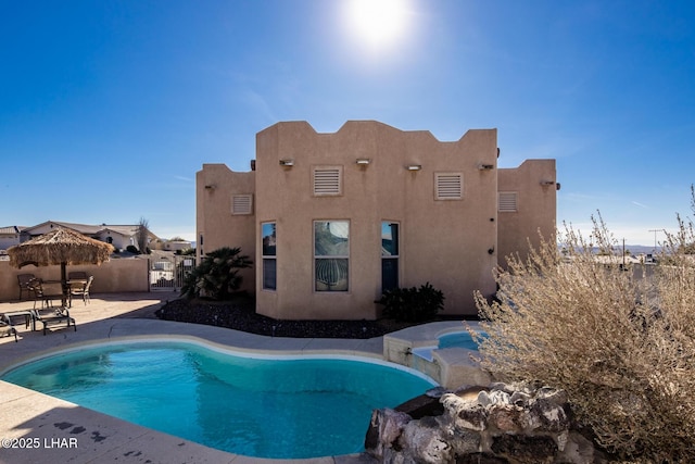 view of swimming pool featuring a fenced in pool, fence, and a patio