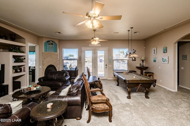 interior space featuring carpet floors, arched walkways, and plenty of natural light