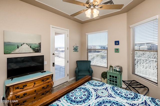 bedroom featuring access to exterior, visible vents, ceiling fan, and multiple windows