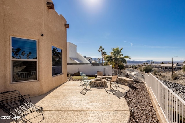 view of patio with an outdoor fire pit and a fenced backyard