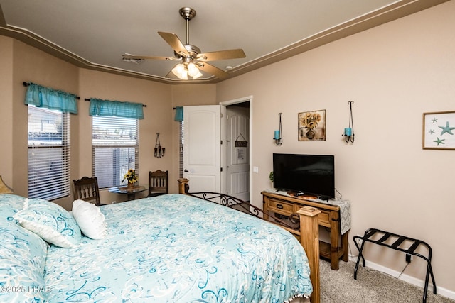 carpeted bedroom with ceiling fan and baseboards