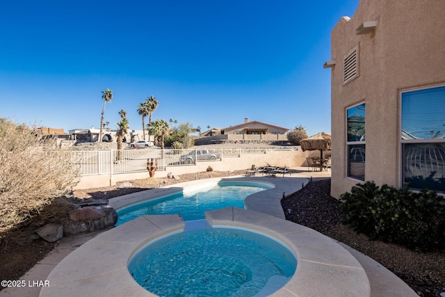 view of pool with a fenced in pool, a fenced backyard, and an in ground hot tub