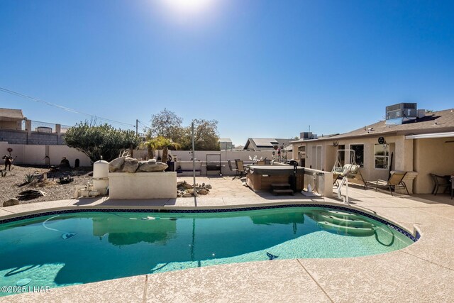 view of pool featuring a hot tub, cooling unit, and a patio area