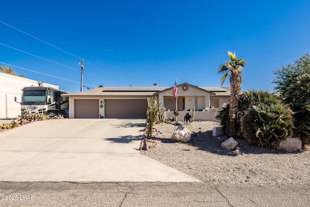 single story home featuring a garage and solar panels