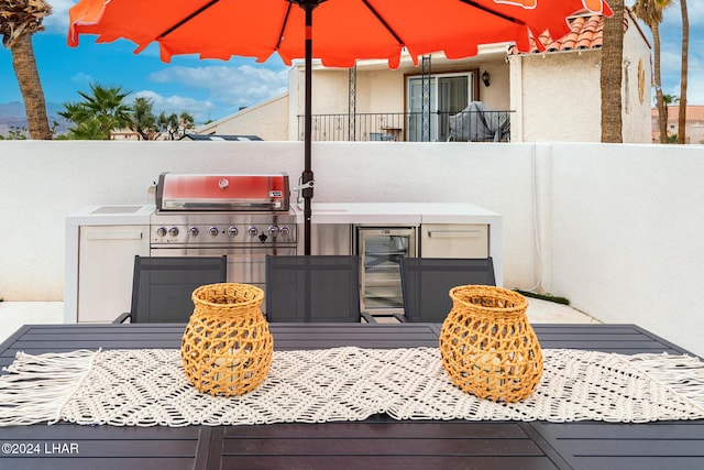 view of patio with exterior kitchen and fence