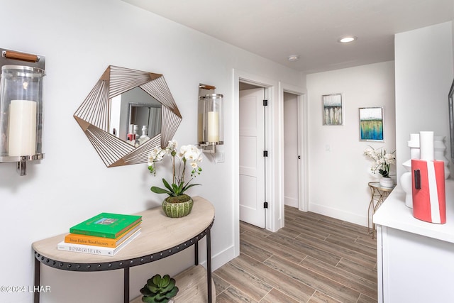 hallway featuring recessed lighting, baseboards, and light wood finished floors