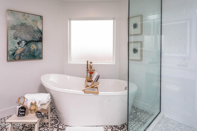 full bath featuring a freestanding tub and tiled shower